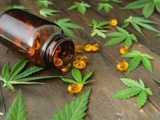 CBD Capsules scattered around a bottle